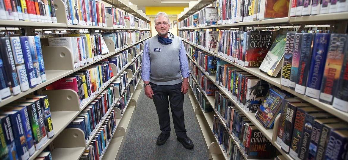 John Hartung stands in the Post Falls Library. He retired Friday after 41 years as director of the Community Library Network.