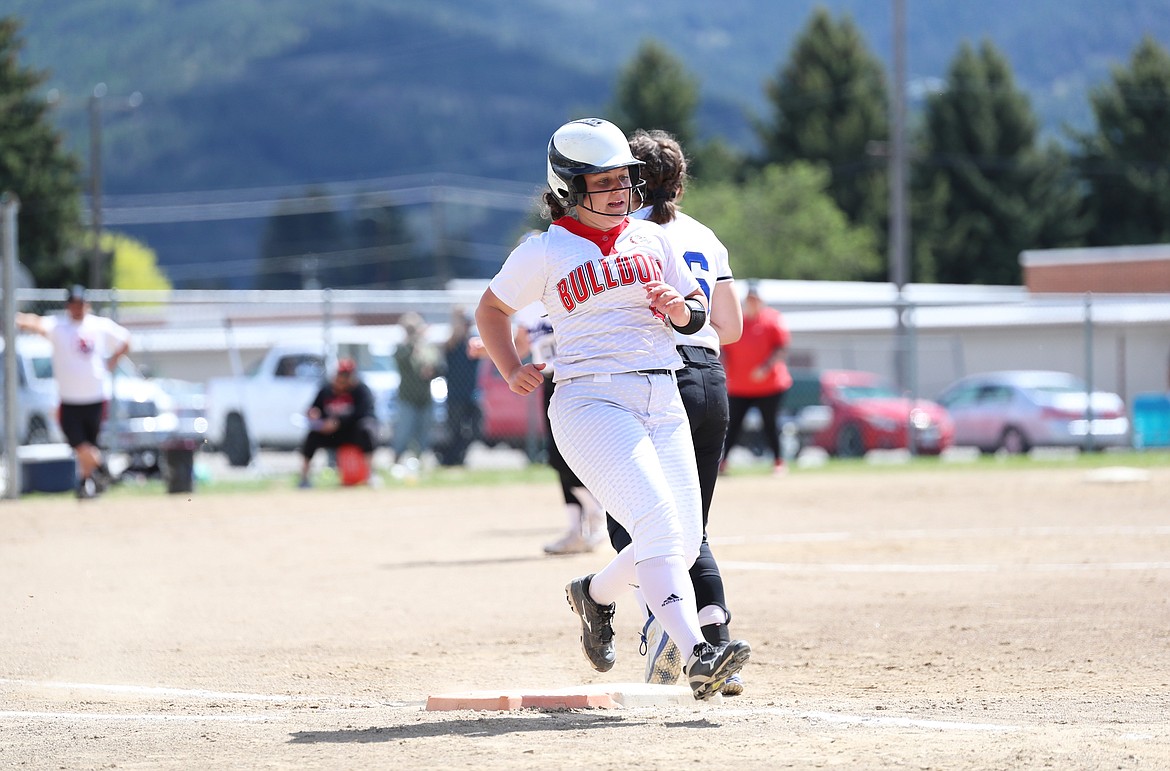 Senior Kinzie Ward crosses first base on Saturday.