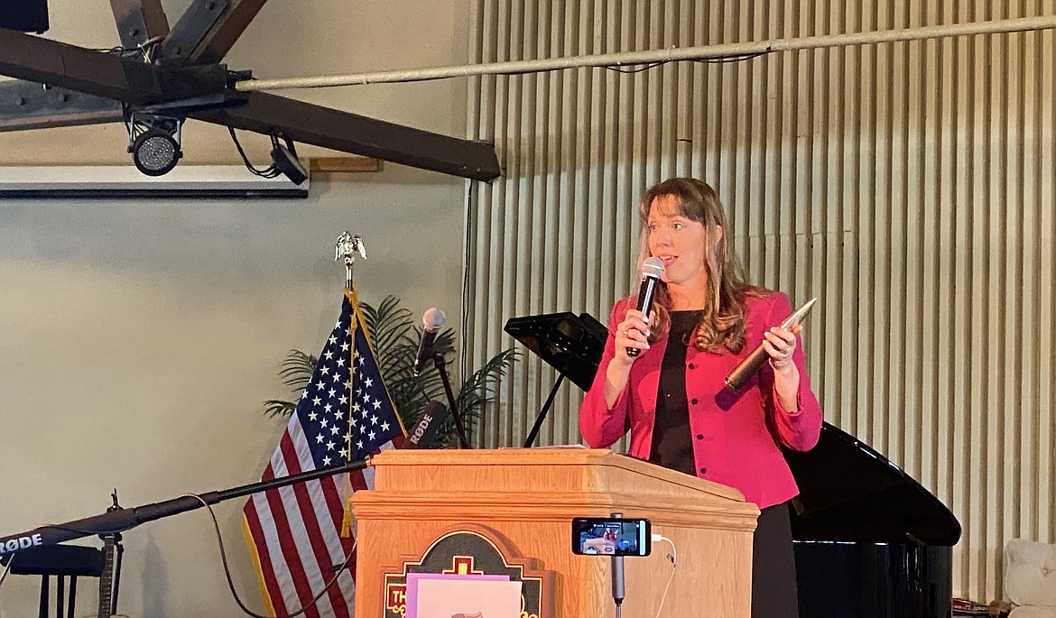 Former fighter pilot Rep. Priscilla Giddings, R-White Bird, holds up an A10 ammunition during her speech with the North Idaho Freedom Fighters Saturday morning. (MADISON HARDY/Press)