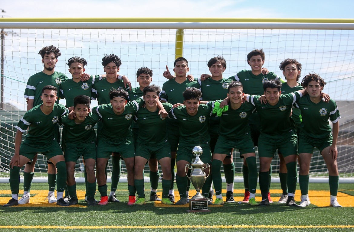 Quincy High School boys soccer team pose with their Battle of the Basin trophy after defeating Ephrata High School in penalty kicks, 4-3, on Saturday in Quincy.