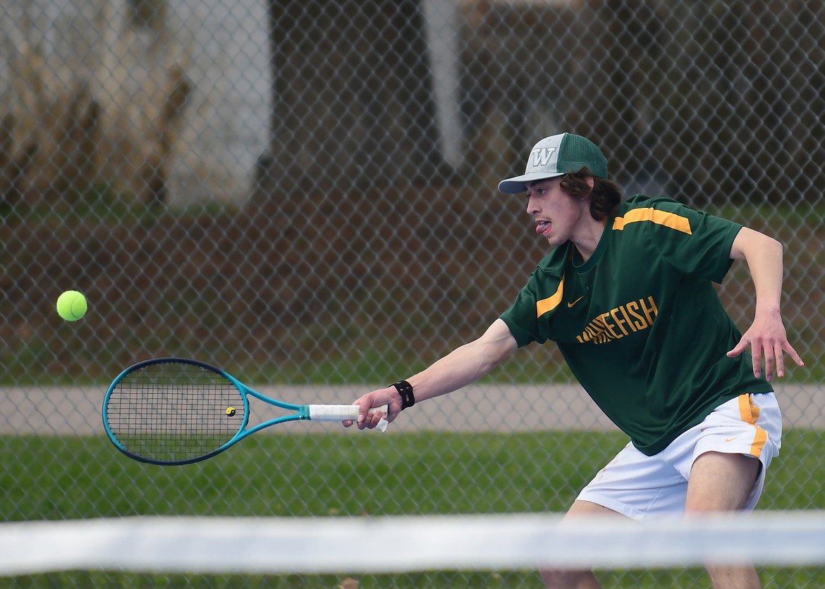 Bulldog Jayce Cripe looks to hit a return in a No. 1 singles match against Wildcat Niels Getts on Tuesday, April 27 in Columbia Falls. (Teresa Byrd/Hungry Horse News)