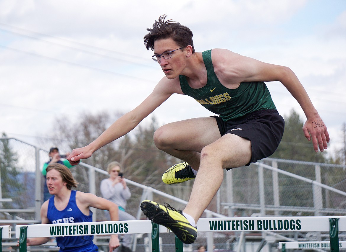 Bulldog Gavin Carmichael competes in the 110 meter hurdles Tuesday at Whitefish High School. (Matt Weller photo)