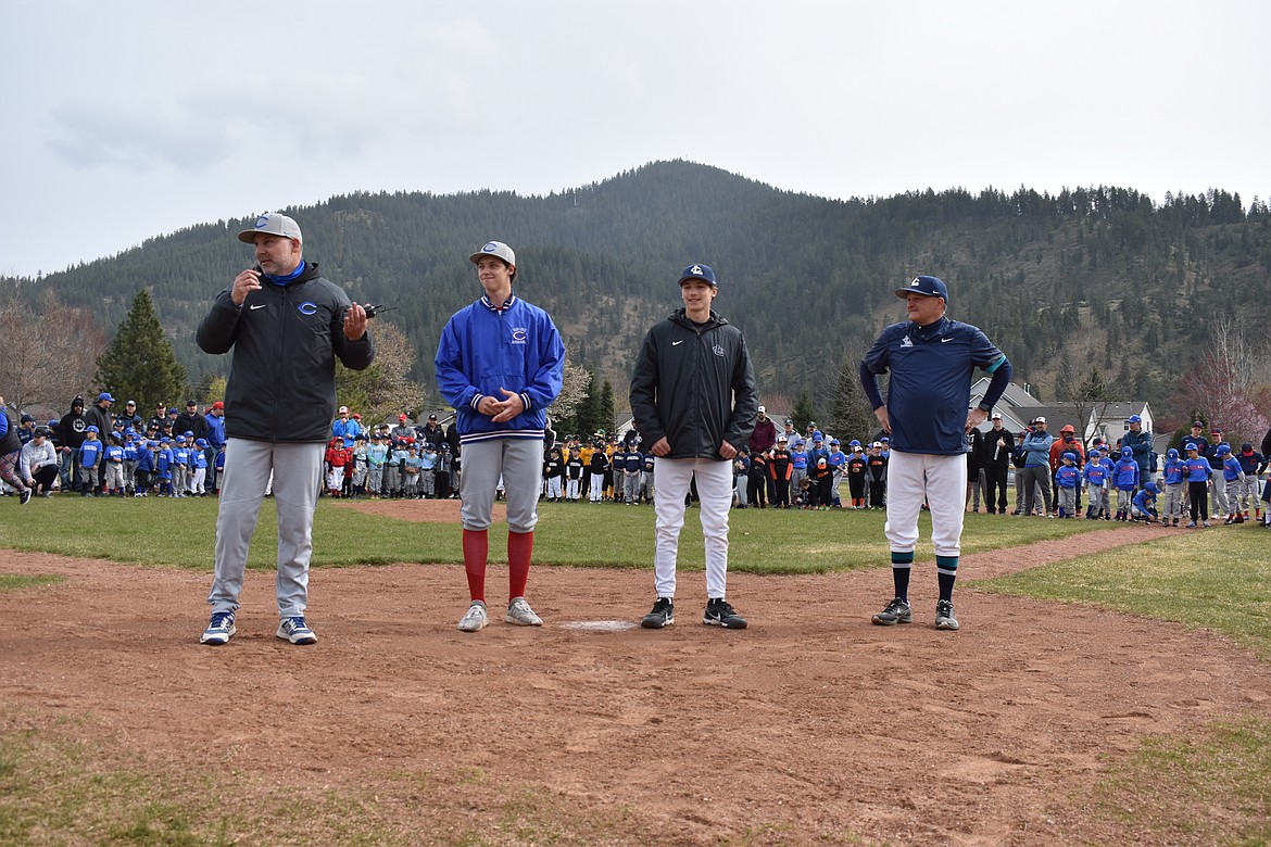 Photo by JEFFREY SMITH
Erik Karns, left, a former Coeur d'Alene Little League coach, speaks to Coeur d'Alene Little League players, coaches and fans at the league's opening day ceremonies April 24. From left is Karns, Coeur d'Alene High head baseball coach; Alex Karns, Coeur d'Alene High senior and Coeur d'Alene Little League scholarship recipient; Marcus Manzardo, Lake City High senior and Coeur d'Alene Little League scholarship recipient; and Paul Manzardo, Lake City High head baseball coach, and former Coeur d'Alene Little League coach.