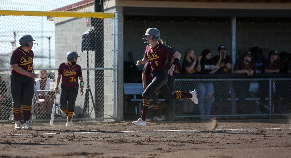 Sidney Ries comes into home plate to score on Tuesday afternoon for Moses Lake High School. Ries finished 3-4 from the plate in the 9-8 win over Eastmont High School.