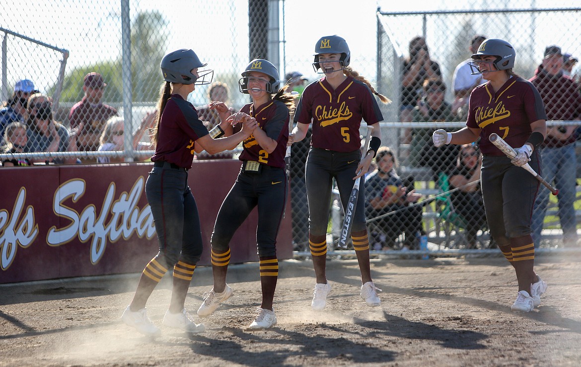 Raegan Hofheins (2) celebrates with her teammates at home plate after bunting for a home run in the bottom of the sixth inning against Eastmont High School on Tuesday.