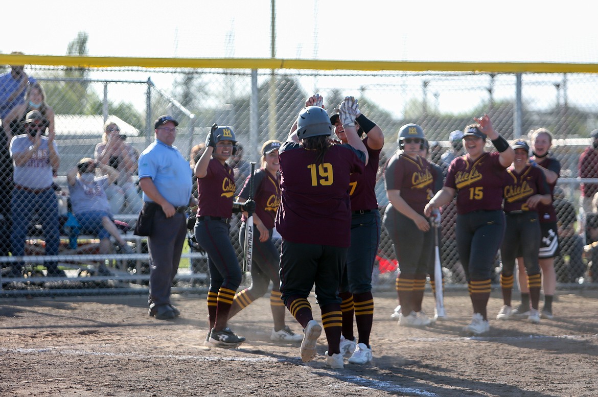 Brenna Rangel celebrates the walk-off win with her teammates after driving in the winning run in the bottom of the seventh inning against Eastmont High School on Tuesday afternoon.