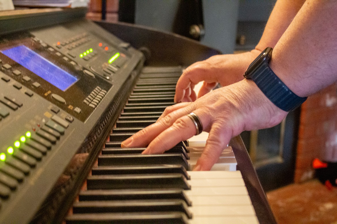 Michael Duvall plays the piano inside his living room at home in Moses Lake on Monday evening.