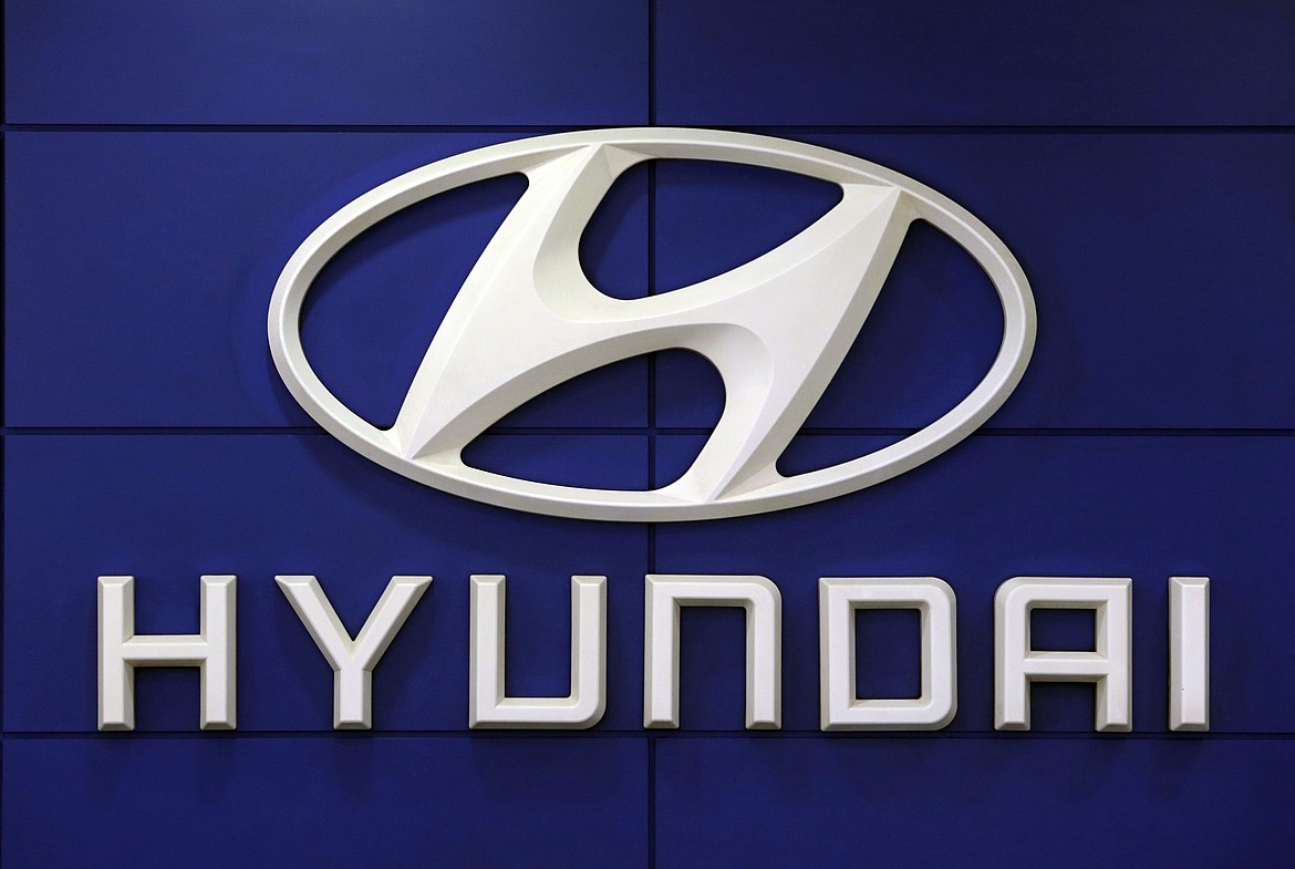 This July 26 2018 file photo shows the logo of Hyundai Motor Co. in Seoul, South Korea. Hyundai is recalling over 390,000 vehicles in the U.S. and Canada, Tuesday, May 4, 2021, for problems that can cause engine fires. In one recall, owners are being told to park outdoors until repairs are made. That recall covers more than 203,000 Santa Fe Sport SUVs from 2013 through 2015.