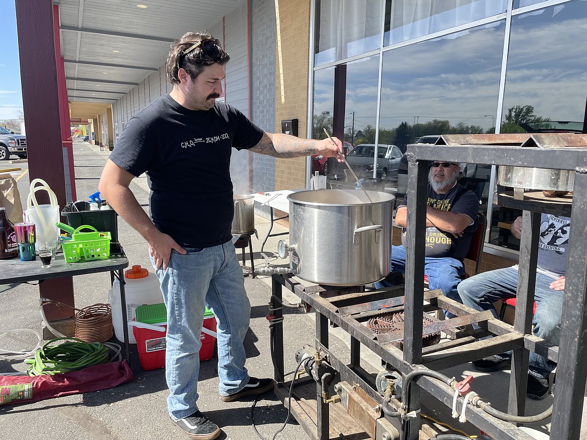 Chris Lamb stirs a pot of wort on Saturday during the local homebrew club’s celebration of National Homebrew Day on Saturday.