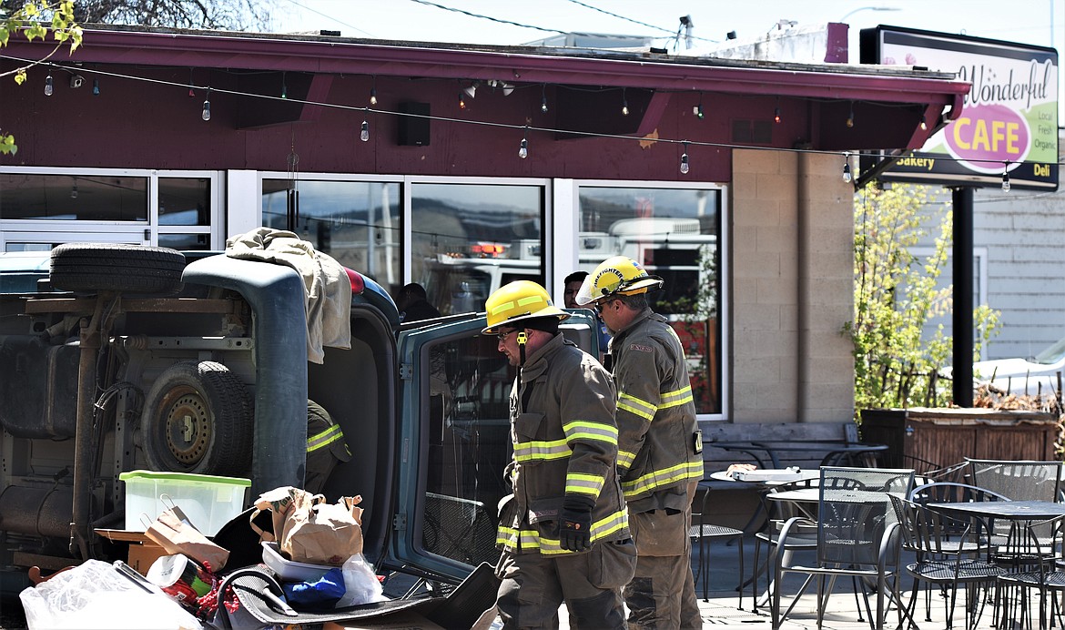 Responders from the Polson Fire Department cleared items from the back of a minivan Monday afternoon so they could free a driver who drove through the entry area of Mrs. Wonderful's Cafe in downtown Polson. (Scot Heisel/Lake County Leader)