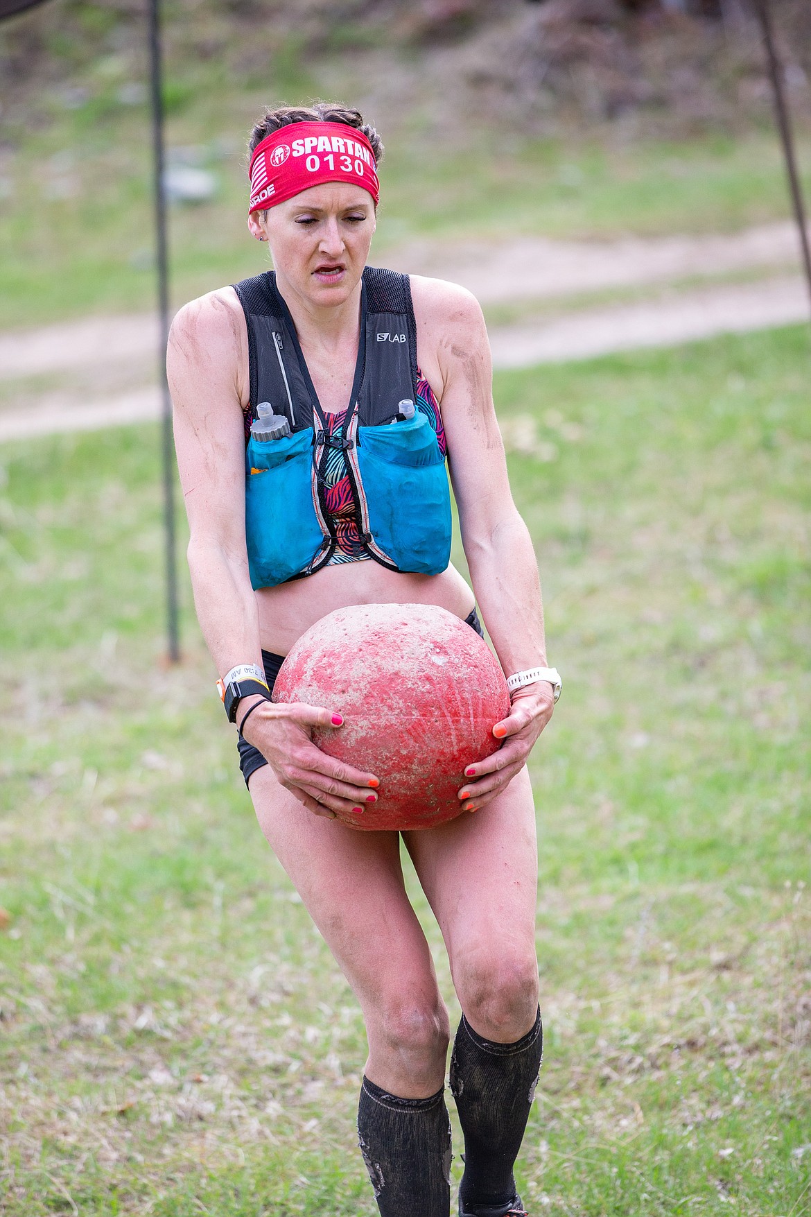 Kaci Monroe, of Bigfork, carries a heavy stone during the Atlas Carry obstacle.
Courtesy Mike Roessmann Photography