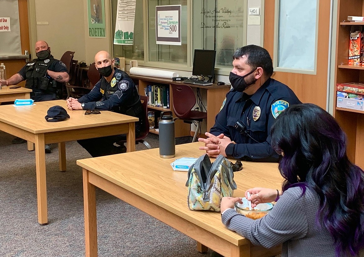 From the left, two Othello Police Department school resource officers, Seth Carlson and Aaron Garza, and Officer Tyson Cox talk about the job of law enforcement at a March meeting with students.