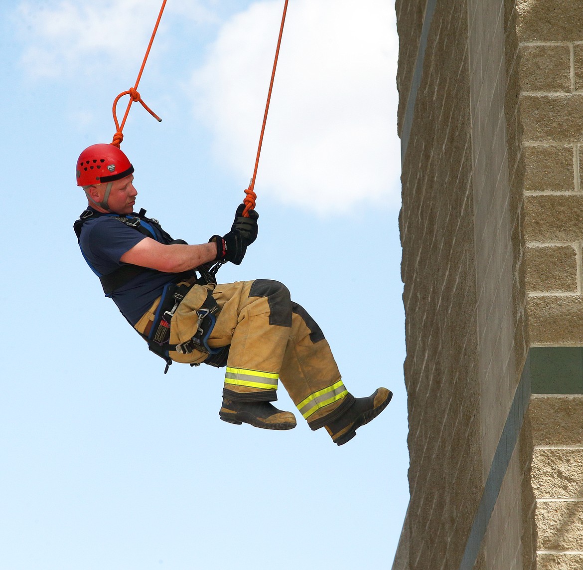 Matt Dilley, emergency vehicle technician with KCFR, rappels down a building on Tuesday during a training day at the KCFR Fire Training Center.