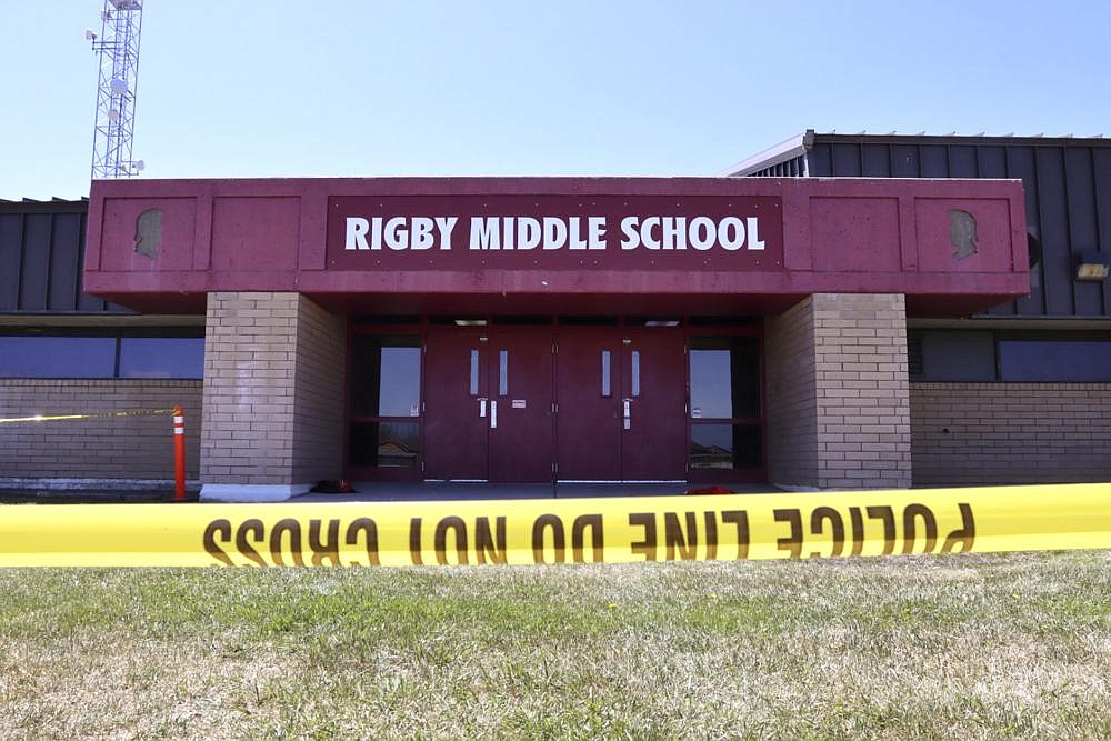 Police tape marks a line outside Rigby Middle School following a shooting there earlier Thursday, May 6, 2021, in Rigby, Idaho. Authorities said that two students and a custodian were injured, and a male student has been taken into custody. (AP Photo/Natalie Behring)