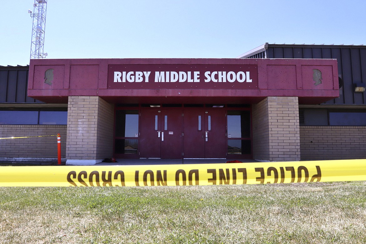 Police tape marks a line outside Rigby Middle School following a shooting there earlier Thursday, May 6, 2021, in Rigby, Idaho. Authorities said that two students and a custodian were injured, and a male student has been taken into custody.