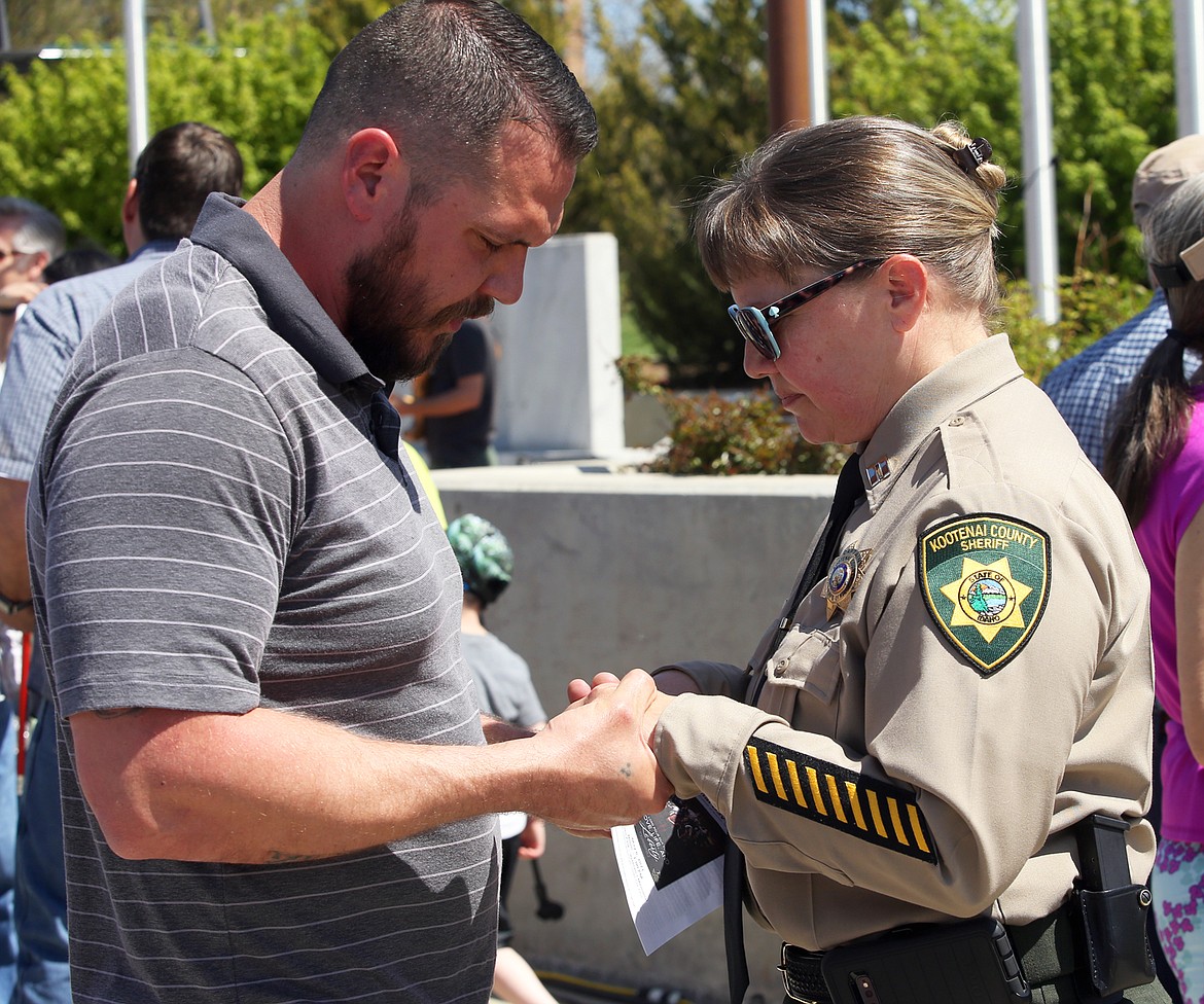 Pastor Steven Hemming of Family Worship Center prays with Kootenai County Sheriff's Capt. Kim Edmonson following the National Day of Prayer in Coeur d'Alene on Thursday.