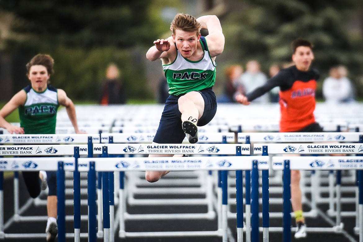 Glacier's Caleb Bernhardt clears a hurdle en route to a first place finish in the boys 110 meter hurdles during a crosstown meet with Flathead at Glacier High School on Friday. (Casey Kreider/Daily Inter Lake)