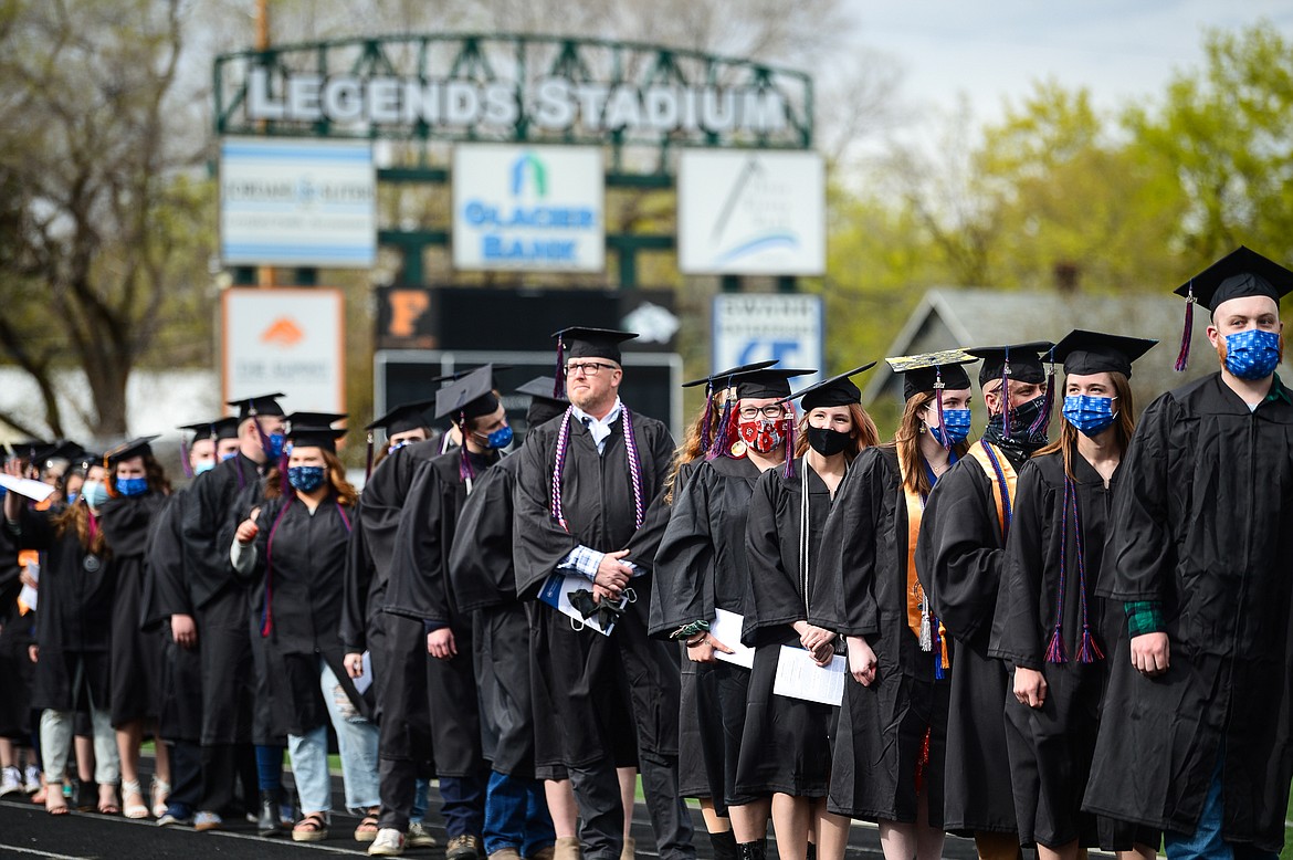 Graduates file into Legends Stadium for Flathead Valley Community College's commencement ceremony on Friday. (Casey Kreider/Daily Inter Lake)