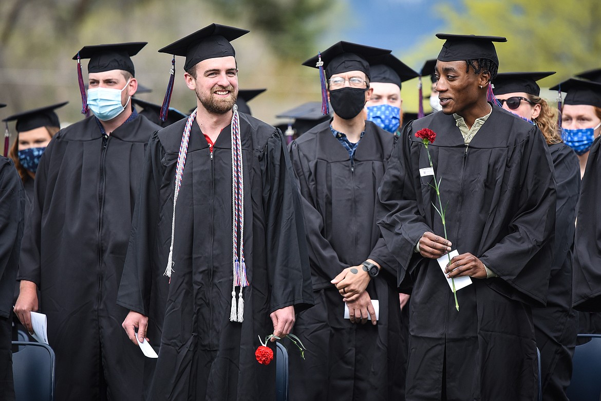 Graduates smile and wave to family and friends before taking their seats during the Flathead Valley Community College commencement ceremony at Legends Stadium on Friday. (Casey Kreider/Daily Inter Lake)