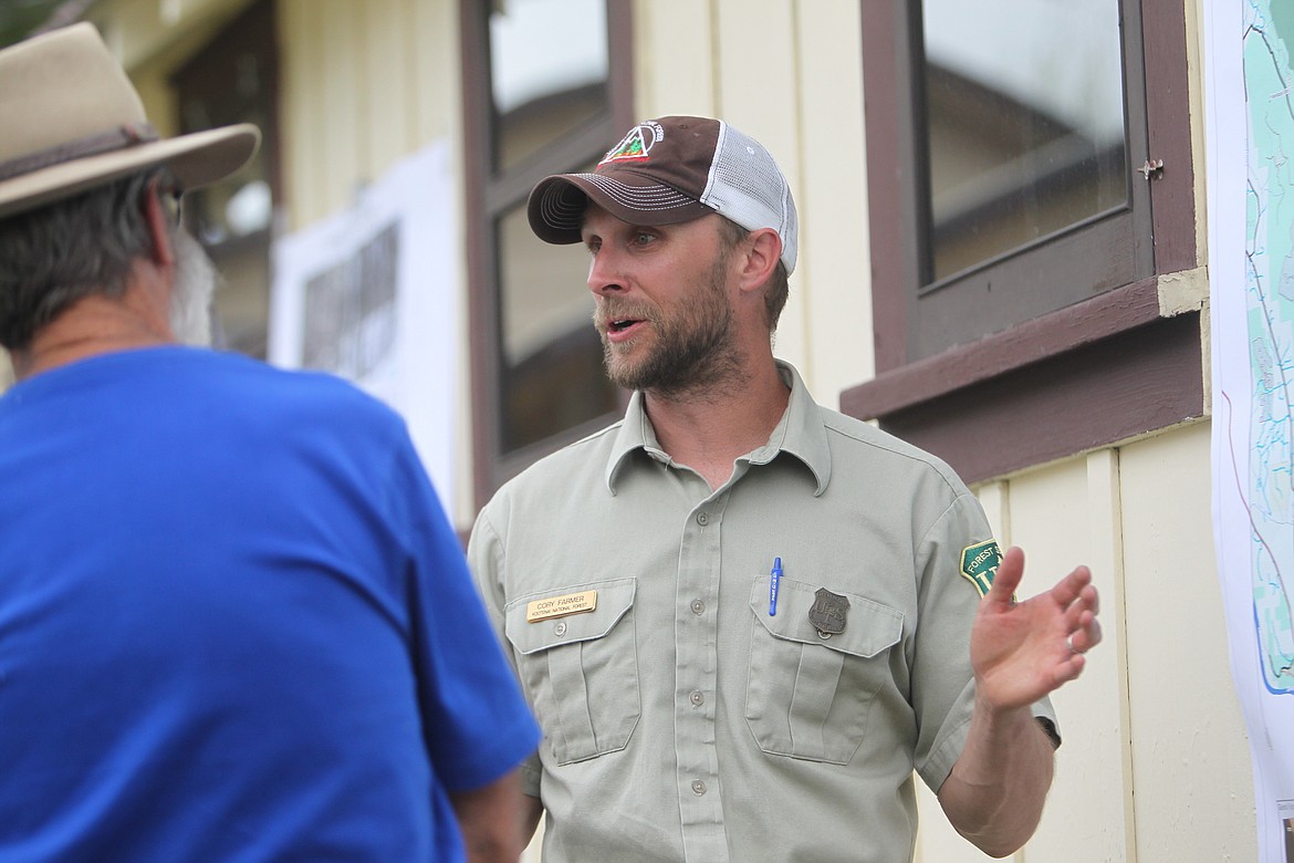 Cory Farmer of the U.S. Forest Service informs residents on the Knotty Pine Project at the Three Rivers Ranger District on May 6. Forest Service officials had to call off a previous public meeting on the project after a small group of residents repeatedly interrupted presenters. The gathering held last week, set up in an "open house" format, was more cordial. (Will Langhorne/The Western News)