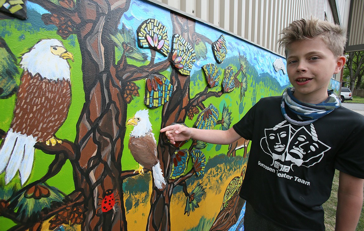 Sorensen fifth-grader Milo Cord on Friday shows off the eagle with a mohawk he painted on the new mural on the school's outer western wall. All kindergarten through fifth grade students took part, contributing their talents to a legacy piece that will last for years to come.