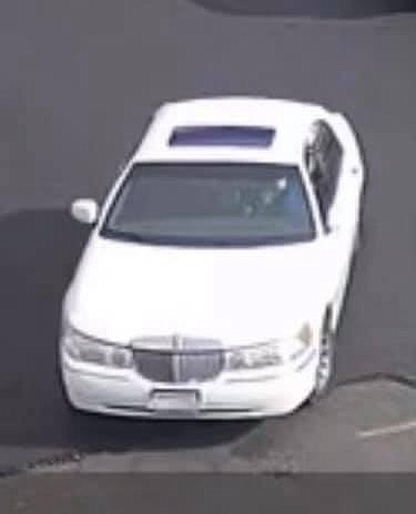 The suspect drove off in this white Lincoln Town Car with undecipherable plates.