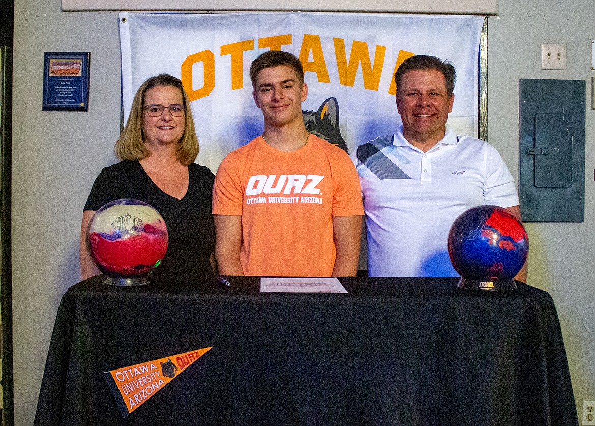 Left to right, Rhonda, Matthew and David Berg pose together at Lake Bowl in Moses Lake Thursday afternoon to celebrate Matthew Berg signing to continue his bowling career at Ottawa University's campus in Surprise, Arizona next fall.