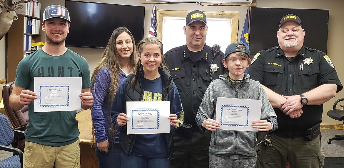 The Mineral County DUI Task Force awarded their annual scholarships based on essay questions. For 2021, since there were no submissions from Alberton, Bailey Milender and Danner Haskins from Superior and Jakob Lohman from St. Regis were the recipients. From left, front row, are Bailey Milender and Jakob Lohman. From left, back row, are Danner Haskins, Stephanie Quick with the DUI Task Force, Sheriff Mike Toth and Undersheriff Wayne Cashman. (Photo courtesy Laurie Johnston)