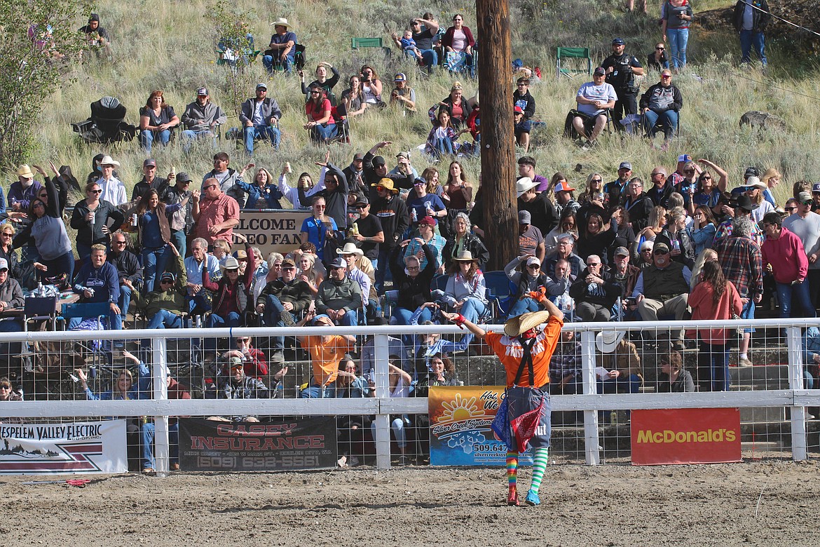 Whistle-Nut the clown dances "YMCA" with the crowd at the 64th Colorama Rodeo in Grand Coulee Saturday.