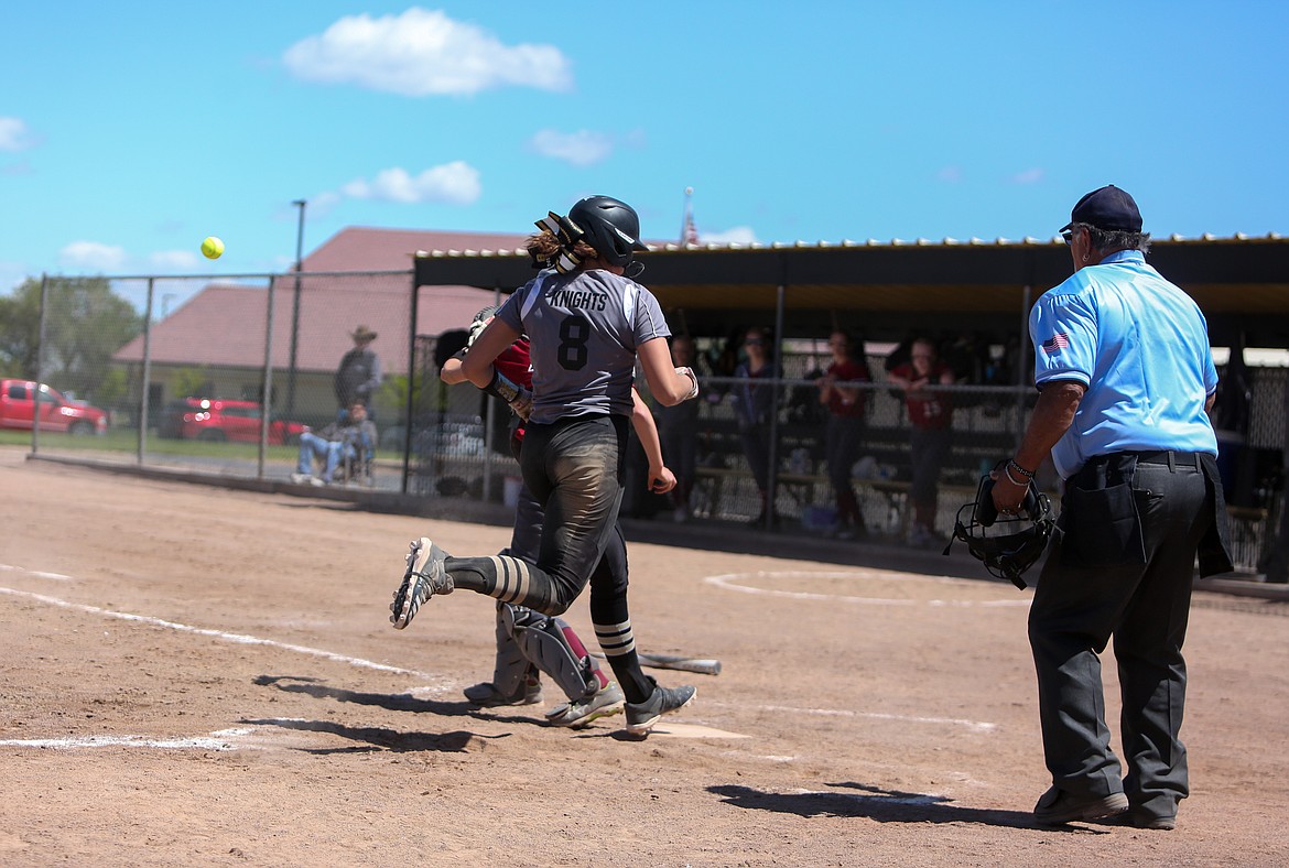 Royal High School's Chenoa Louie comes across the plate to score on Saturday afternoon in the win over Okanogan High School.