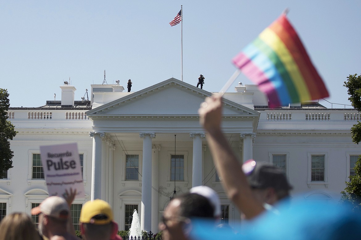 In this Sunday, June 11, 2017 file photo, Equality March for Unity and Pride participants march past the White House in Washington. The Biden administration says the government will protect gay and transgender people against sex discrimination in health care. That reverses a Trump-era policy that sought to narrow the scope of legal rights in sensitive situations involving medical care. Health and Human Services Secretary Xavier Becerra said Monday that LGBTQ people should have the same access to health care as everyone else.