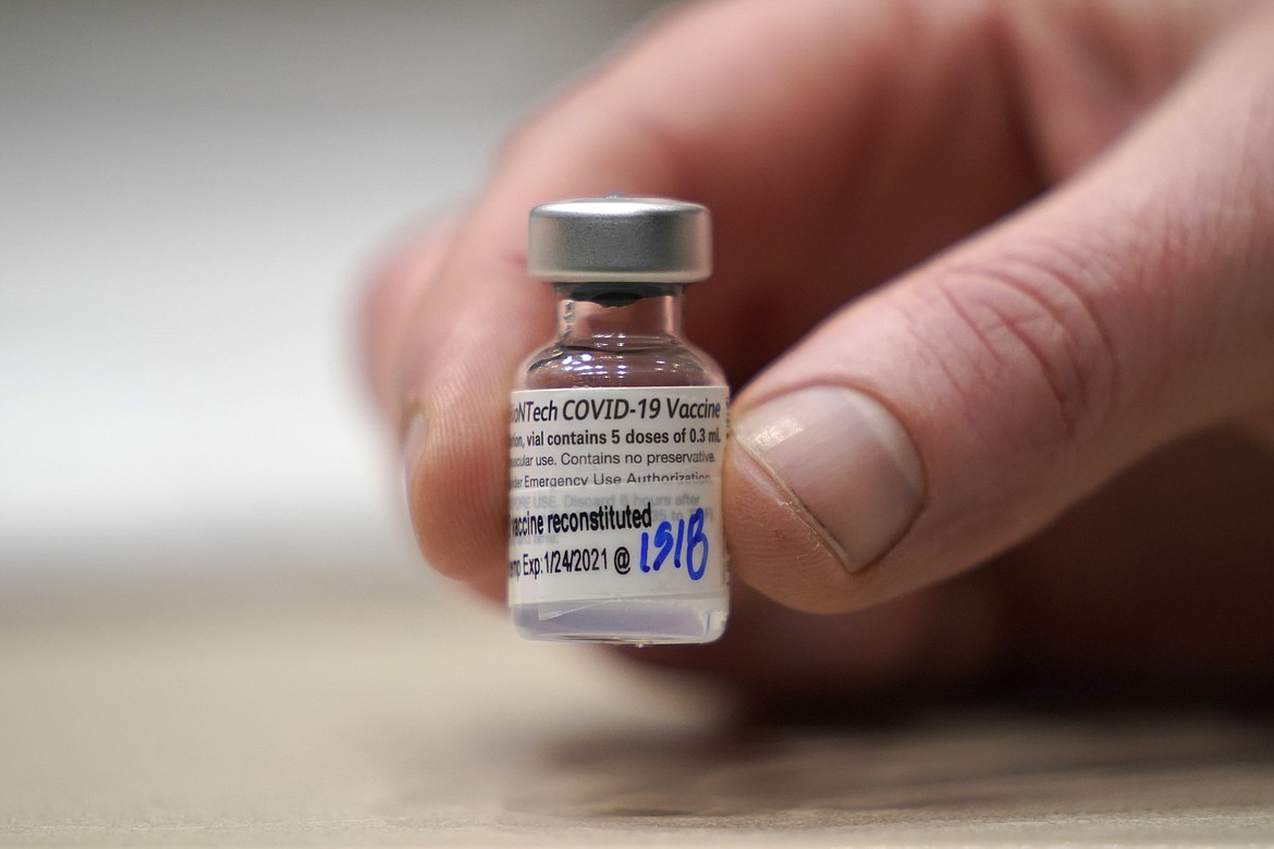 This Jan. 24, 2021, file photo shows a vial of the Pfizer vaccine for COVID-19 in Seattle. U.S. regulators on Monday, May 10, 2021, expanded use of Pfizer's shot to those as young as 12, sparking a race to protect middle and high school students before they head back to class in the fall.