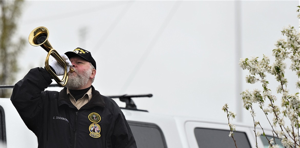 Commander Glen Sharbono plays taps during an Honor Guard ceremony for Mick Holien. (Scot Heisel/Lake County Leader)