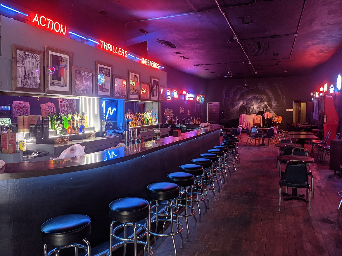 The neon lights of the Dayrock Underground illuminate the bar area and dance floor.