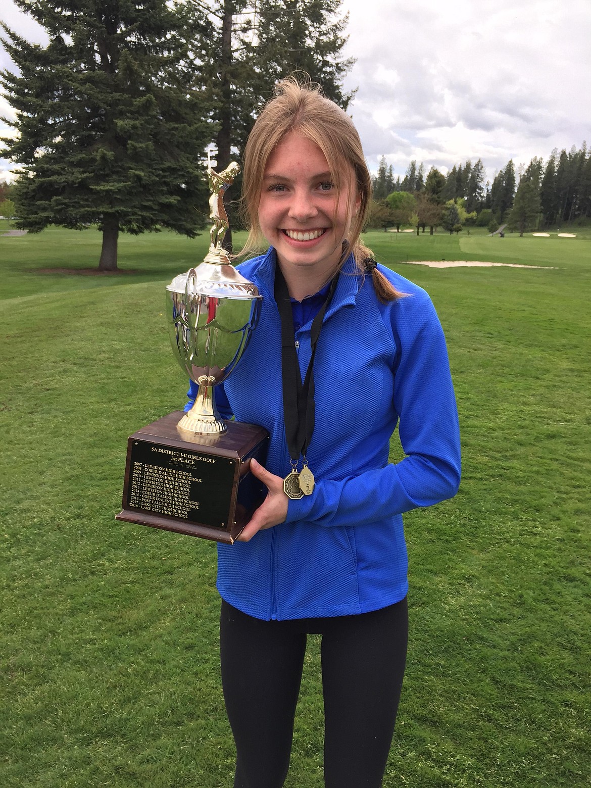 MARK NELKE/Press
Coeur d'Alene High junior Paige Crabb, holding the team trophy, earned girls medalist honors as the Viking girls won the team title at the 5A Region 1 golf tournament Monday at Avondale Golf Club in Hayden Lake.