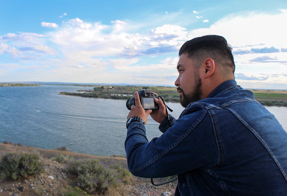 Dino Gonzales holds up a camera looking over his hometown of Moses Lake on Monday afternoon, the sight and setting for his upcoming movie he's set to begin filming this summer.
