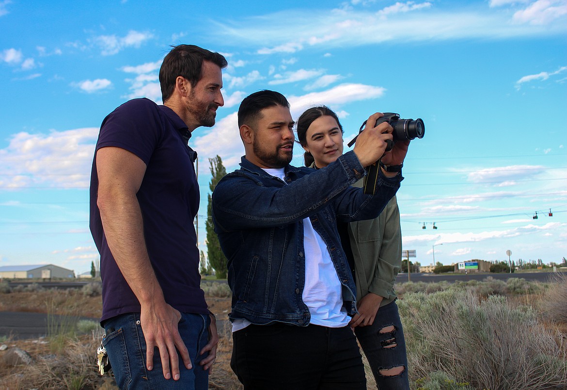 Left to right, Jared Coon, Dino Gonzales and Jewel Mauceri look into the viewfinder on a camera as the trio get set to embark on filming Gonzales' new film this summer in and around Moses Lake.