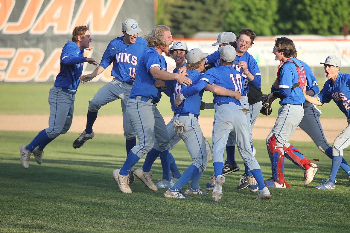 MARK NELKE/Press
Coeur d'Alene players celebrate after beating Post Falls 5-4 in 10 innings to win the 5A Region 1 baseball championship Tuesday at Post Falls High.