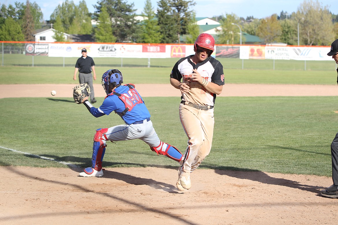 MARK NELKE/Press
Kaden Cripps of Post Falls scores to tie the game at 4-4 in the fifth inning, as Coeur d'Alene catcher Wade Mallory awaits the throw.