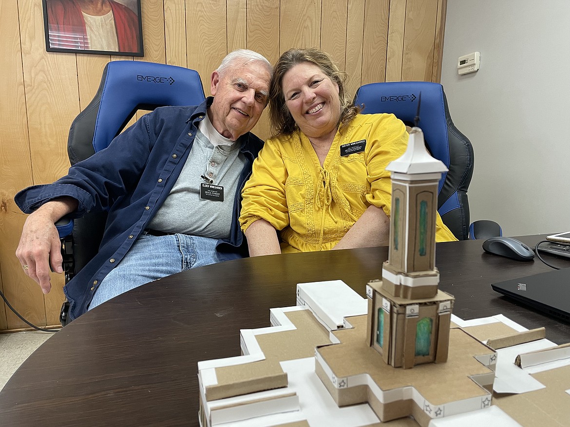 Charles and Beverly Winegarden, pictured with a paper model of the Moses Lake temple currently under construction, are both missionaries with The Church of Jesus Christ of Latter-day Saints at the church’s temple construction site.