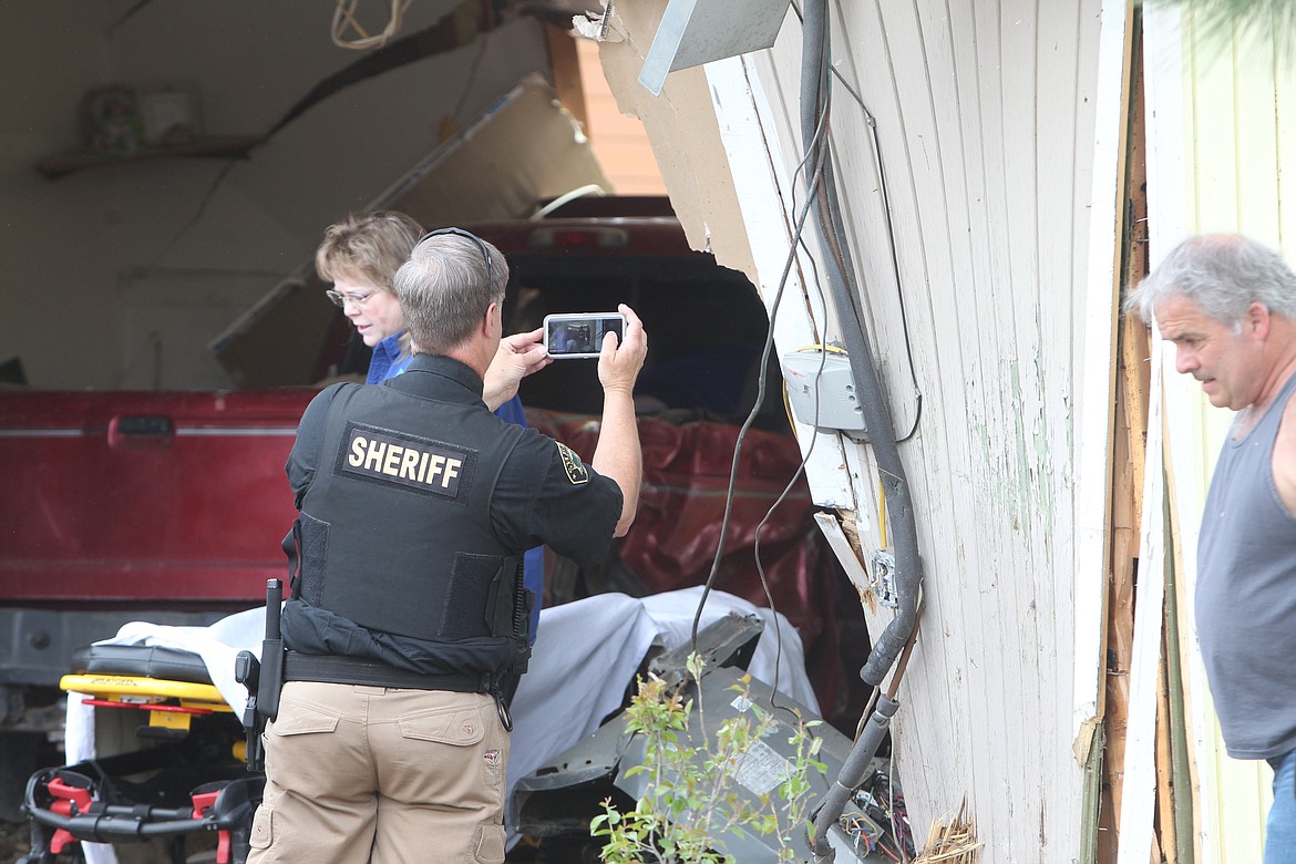 A red truck southbound on U.S. Highway 2 careened off the road, hit a telephone poll and rammed through a building just outside of Libby on May 12. Libby Volunteer Ambulance, Lincoln County Sheriff's Office and Libby Volunteer Fire Department responded to the scene.  (Will Langhorne/The Western News)