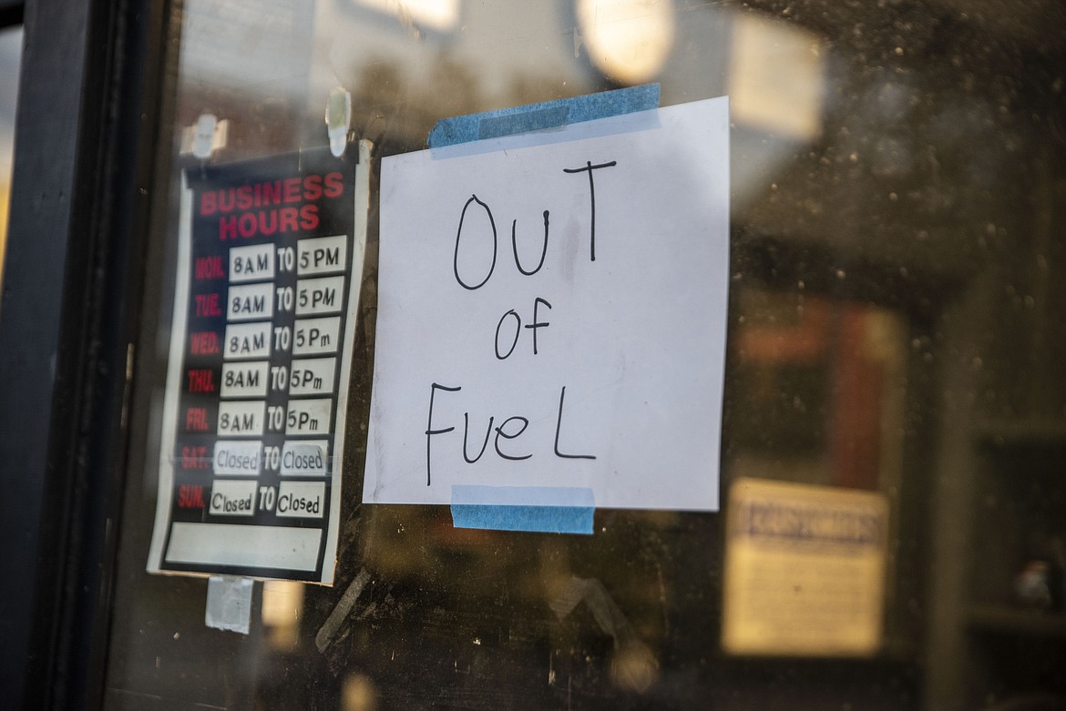 A sign reading "Out of Fuel" is taped to the window at an Exxon Gas Station on Boonsboro Road in Lynchburg, Va., Tuesday, May 11, 2021. More than 1,000 gas stations in the Southeast reported running out of fuel, primarily because of what analysts say is unwarranted panic-buying among drivers, as the shutdown of a major pipeline by hackers entered its fifth day. In response, Virginia Gov. Ralph Northam declared a state of emergency.