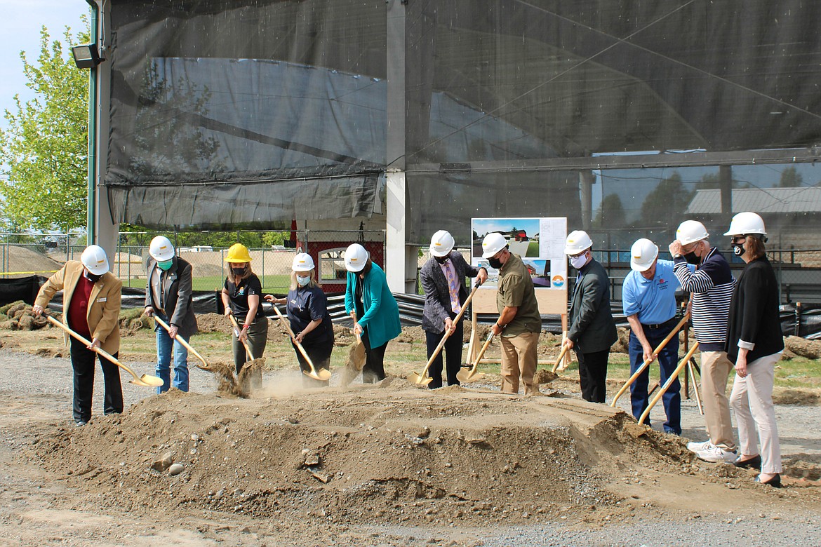 Left to right: Council member Michael Riggs, State Representative Tom Dent, Parks Director Susan Schwiesow, council member Karen Leibrecht, Senator Judy Warnick, Mayor David Curnel, former Parks Director Spencer Grigg, council member Don Myer, Deputy Mayor Daryl Jackson, Council member Dean Hankins and City Manager Allison Williams dig into the dirt at the groundbreaking ceremony for the new Larson Recreation Center on Wednesday.