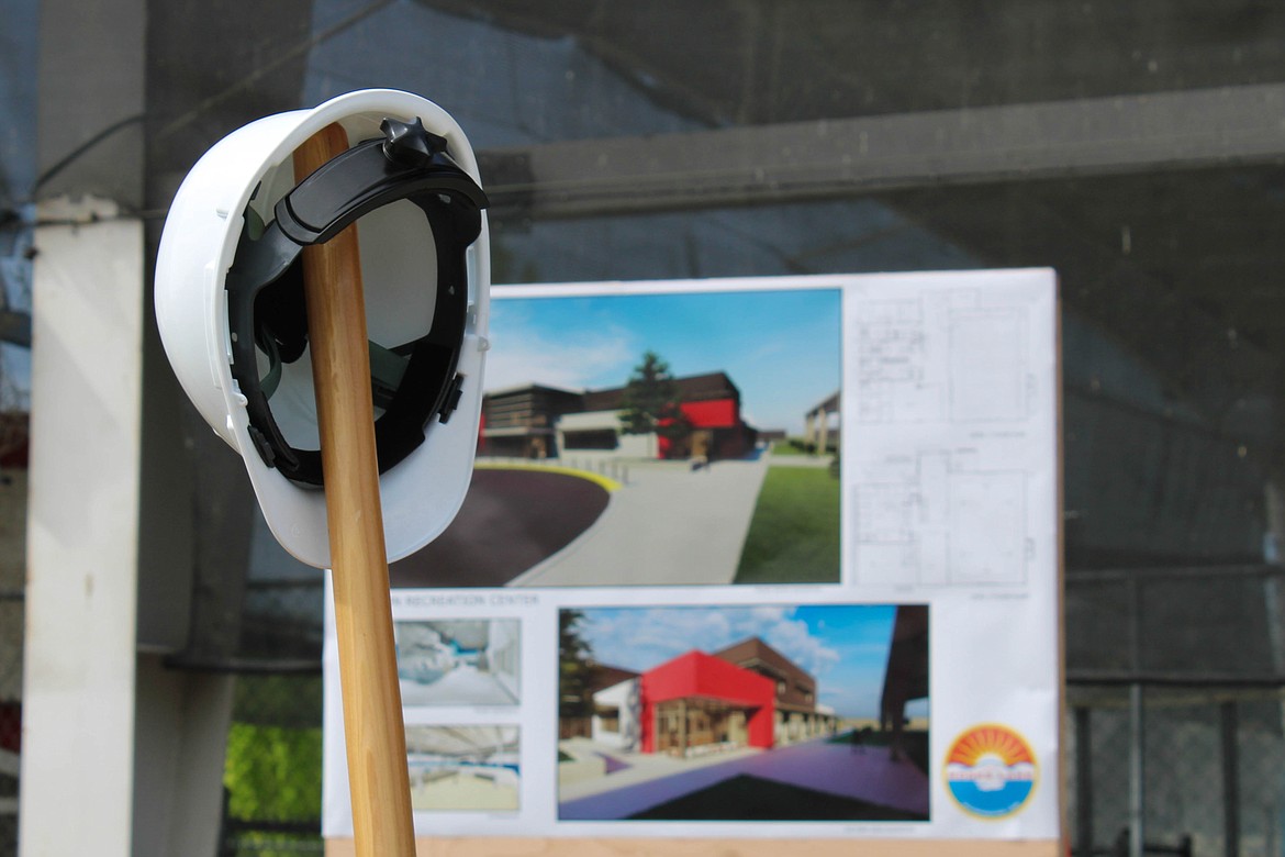 A hardhat and a ceremonial shovel in front of a rendering for the new Larson Recreation Center at 610 Yakima Avenue in Moses Lake.