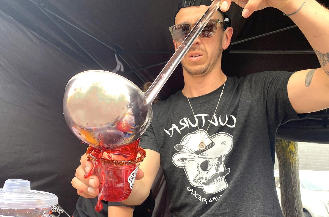 First year vendor and Cultura CDA owner Steven Sanchez pours up a cup of Jamaica Agua Fresca at the Kootenai County Farmers' Market Wednesday afternoon. (MADISON HARDY/Press)