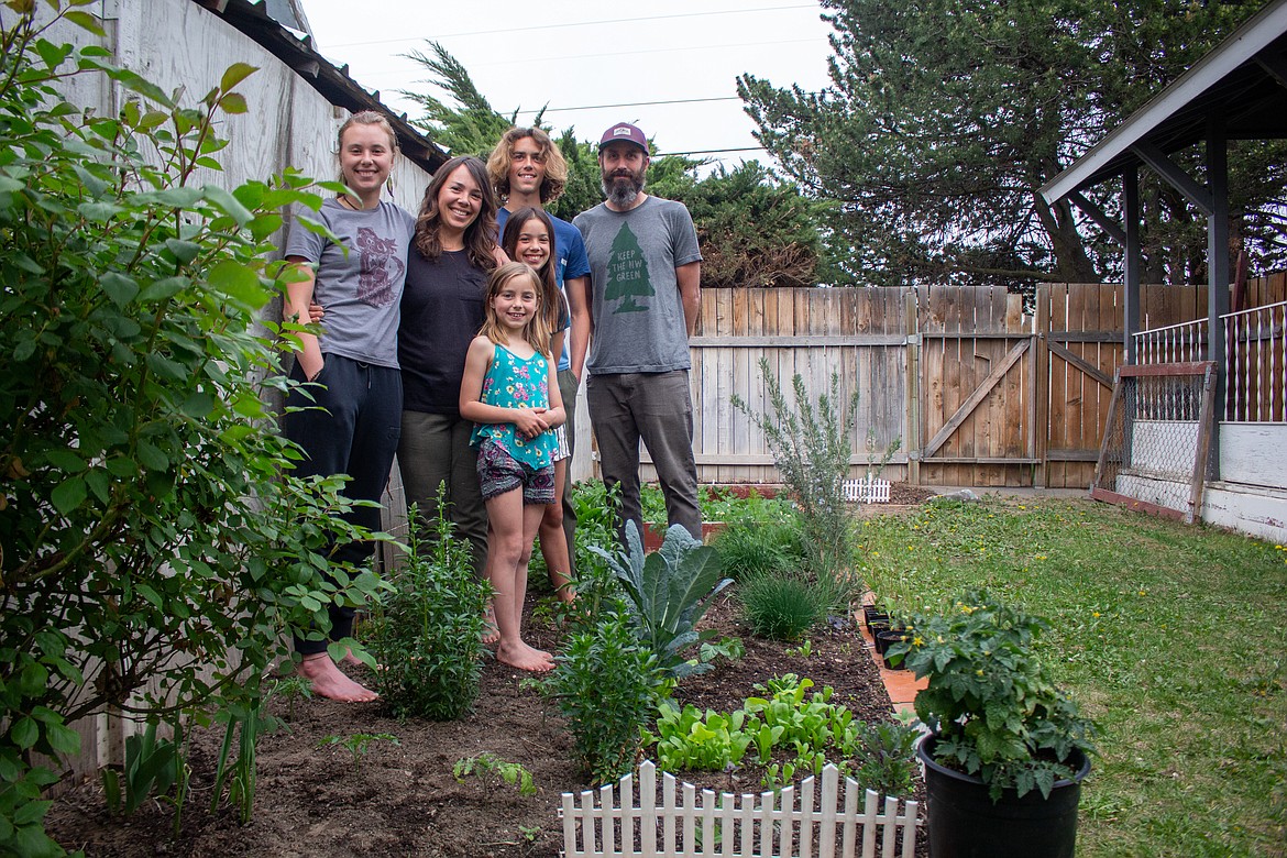 Left to right, Amerae, Alicia, Amelia, Janell, Jackson and Josh Mohs stand beside the family’s garden behind their home in Moses Lake.