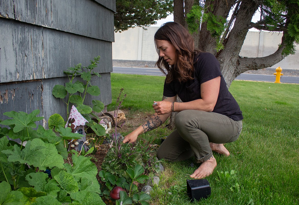 Alicia Mohs plants some new things in the small garden area in front of her home in Moses Lake.