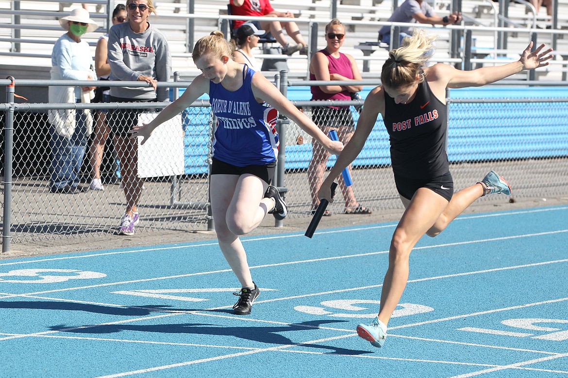 JASON ELLIOTT/Press
Post Falls High senior Dylan Lovett beats Coeur d'Alene sophomore Emily Dodd to the finish line in the 5A girls 4x200 relay. Lake City won the event in 1 minute, 44.14 seconds, followed by Post Falls in second in 1:47.13.