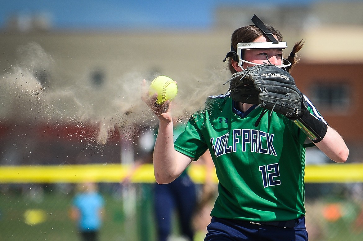 Dirt flies out of the glove of Glacier third baseman Ella Farrell (12) after fielding a grounder against Flathead at Glacier High School on Thursday. (Casey Kreider/Daily Inter Lake)