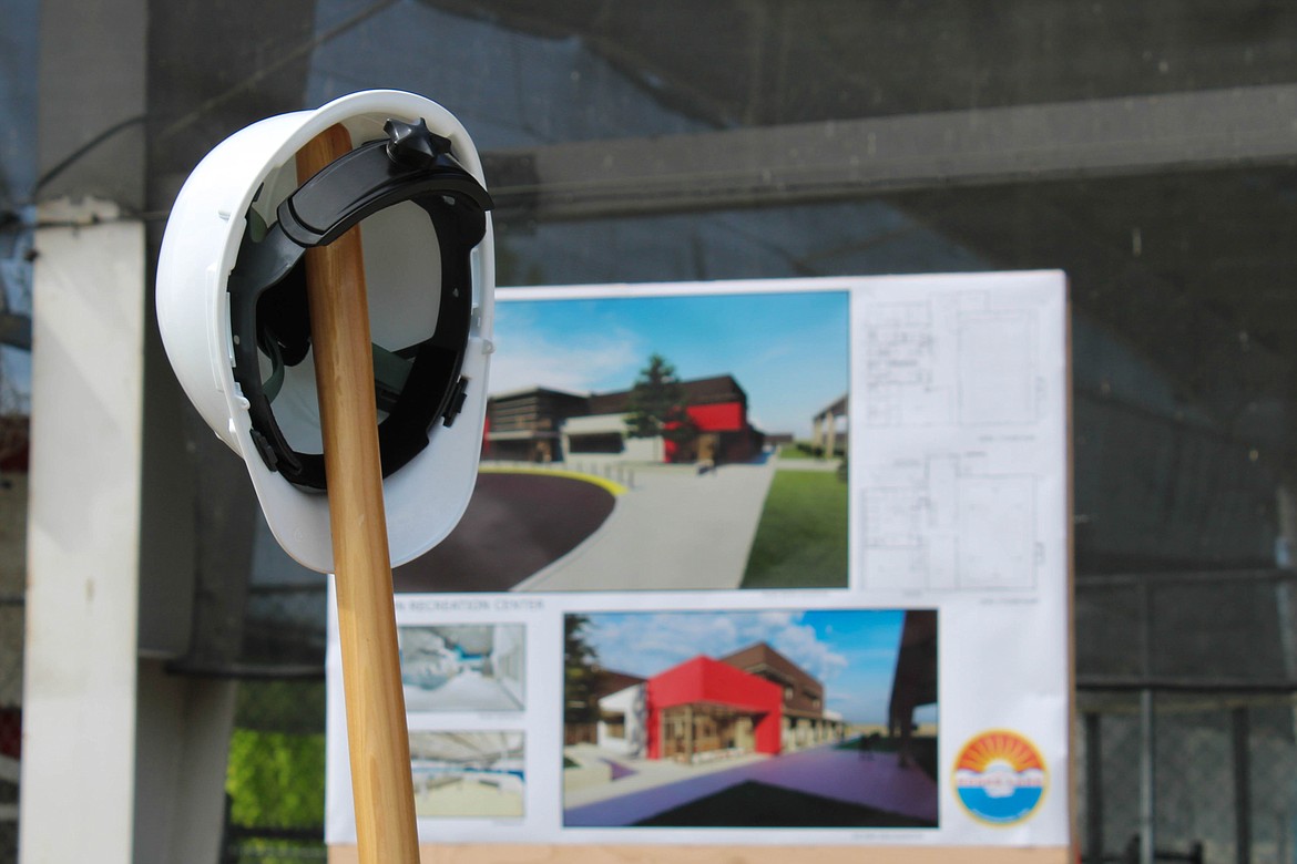 A hardhat and a ceremonial shovel in front of a rendering for the new Larson Recreation Center at 610 Yakima Ave. in Moses Lake.